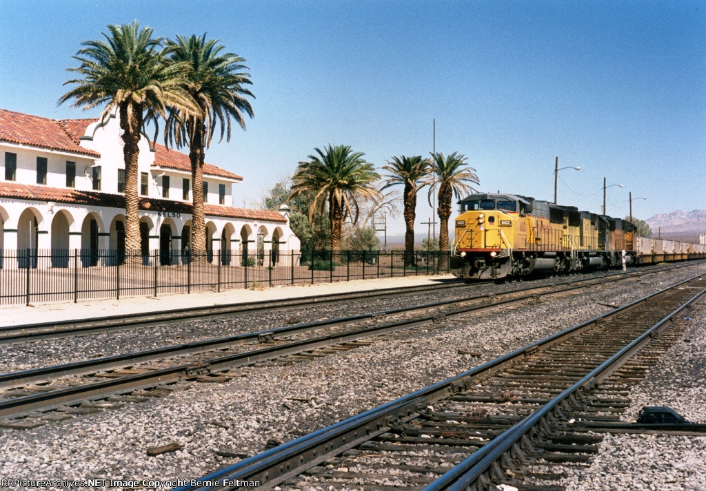 Union Pacific SD60M #6102 (SD60M) leading a container stack train past the depot